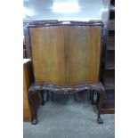 A Queen Anne style mahogany two door cabinet on stand