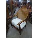 An Art Deco beech bergere fireside armchair