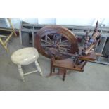 A mahogany spinning wheel and a beech stool