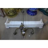 A small Victorian painted cast iron fender and an Art Deco brass ceiling light