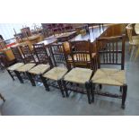 A set of six Georg III style elm and ash spindle back rush seated chairs