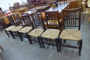 A set of six Georg III style elm and ash spindle back rush seated chairs
