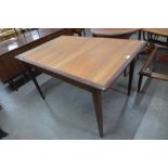 A teak extending dining table