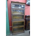 An early 20th Century carved oak six tier sectional stacking bookcase