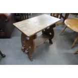 An Arts and Crafts oak two tier occasional table
