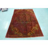 A hand knotted Persian red ground Heriz rug, 280 x 184cms