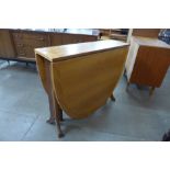 A teak drop-leaf table