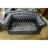 A black leather Chesterfield settee