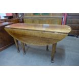 A George II style oak gateleg dining table