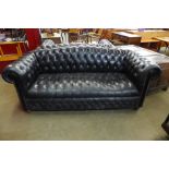 A black leather Chesterfield settee