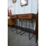 A pair of G-Plan Fresco teak bedside tables, on black metal legs