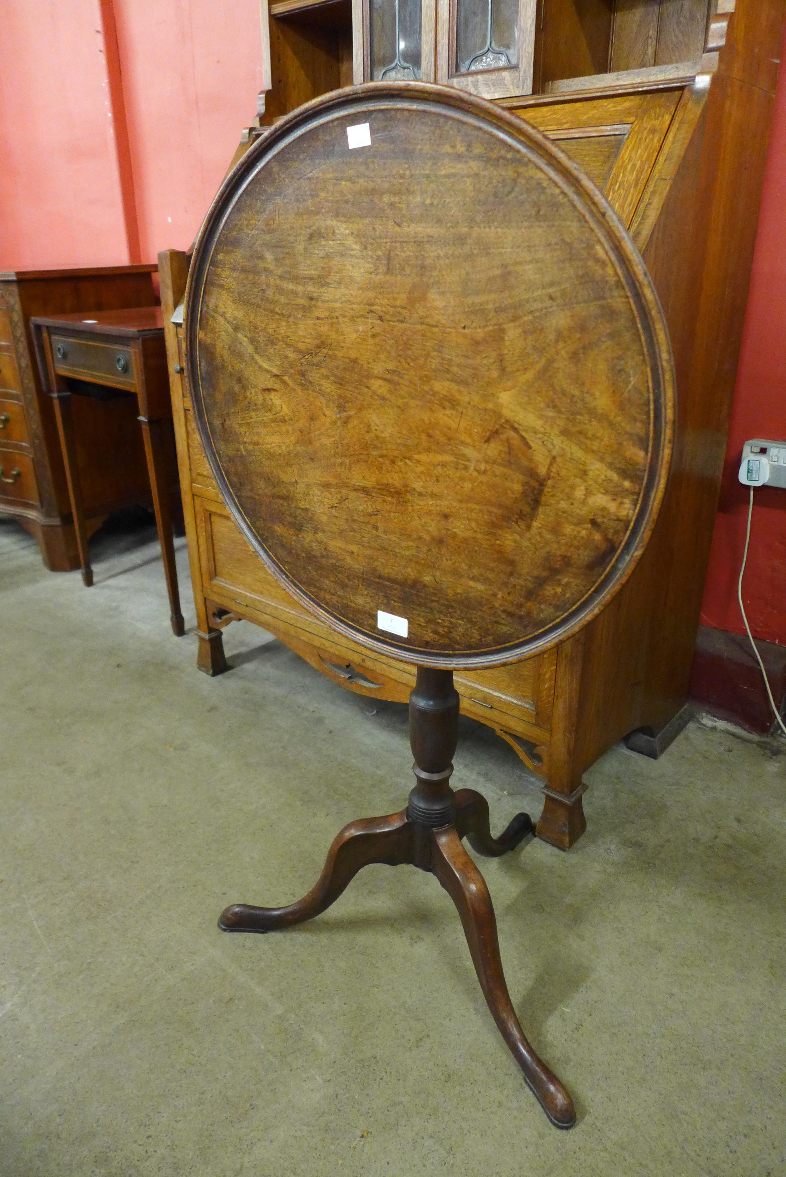 A George III mahogany circular tilt top tripod table