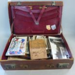 A collection of photographs, photographic postcards and greetings cards in a leather case