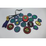 A collection of 1940's Girl Guides uniform patches and two metal badges