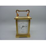 A Woodford brass and four glass sided carriage clock, with presentation plaque