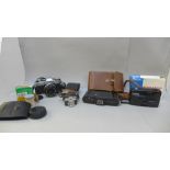 Cameras and accessories including an Olympus OM20 body, a Polaroid and a miniature novelty camera