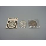 Two U.S. half-dollar coins, 1902 San Francisco mint and 1943, one Canadian one dollar coin, 1935