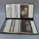 An album of early to mid 20th Century postcards, including three silk