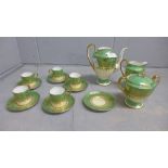 An Aynsley green, gold and white part coffee set comprising five cups, six saucers, cream and