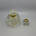 A heavy cut glass inkwell and a smaller glass ink bottle