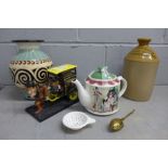 A Ringtons tea comical horse and cart figure, a Goose Fair tea pot, two tea strainers, a stoneware