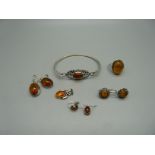 Silver and amber jewellery; a ring, P, bangle, pendant and three pairs of earrings