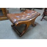 A mahogany and brown leather footstool