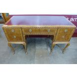 A George I style inlaid walnut and red leather topped writing table