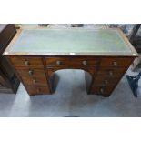 A George IV mahogany and green leather topped kneehole desk