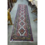 A Persian red ground runner rug