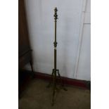 An Arts and Crafts brass and copper floor standing lamp