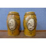 A pair of painted toleware style jars and covers