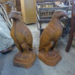 A pair of large cast iron garden figures of eagles