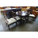A Chinese hardwood extending dining table and six chairs