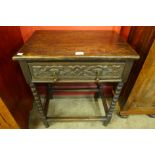 A 17th Century style carved oak single drawer side table