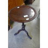 A mahogany tripod wine table