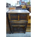 A carved oak cocktail cabinet