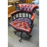 A mahogany and leather revolving Captain's desk chair