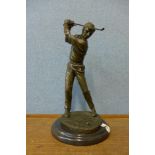 A bronze figure of a golfer, on black marble socle