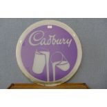 A Perspex Cadburys circular advertising sign