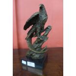 A bronze figure of an eagle, on black marble socle