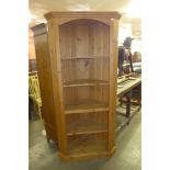 A pine freestanding corner cabinet