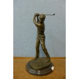 A bronze figure of a golfer, on black marble socle