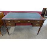 A late Victorian Shapland & Petter of Barnstable mahogany and green leather topped writing table