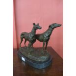 A French style bronze figure of two greyhounds, on black marble plinth