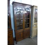 An early 20th Century oak four door bookcase