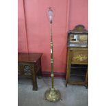 An Arts and Crafts brass telescopic floor standing lamp