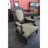 A Victorian carved walnut and fabric upholstered armchair