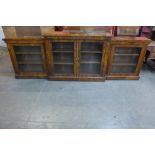 A Victorian walnut four door breakfront bookcase, 103cms h, 298cms w, 38cms d
