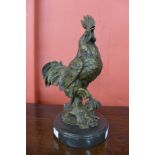 A bronze figure of a cockerel, on black marble socle